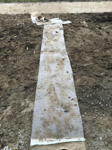Path of carpet to the house over the mud